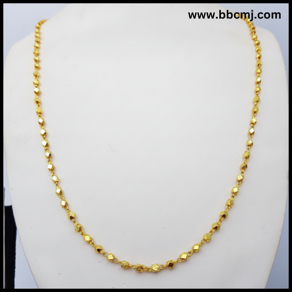 A gold-coated Ashtapailu mala necklace displayed on a mannequin torso.