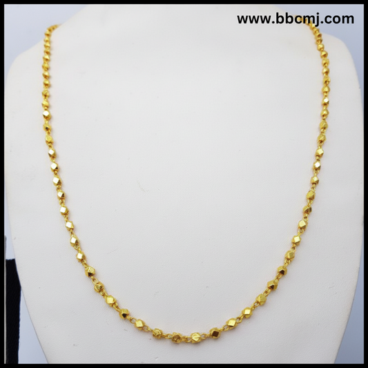A gold-coated Ashtapailu mala necklace displayed on a mannequin torso.