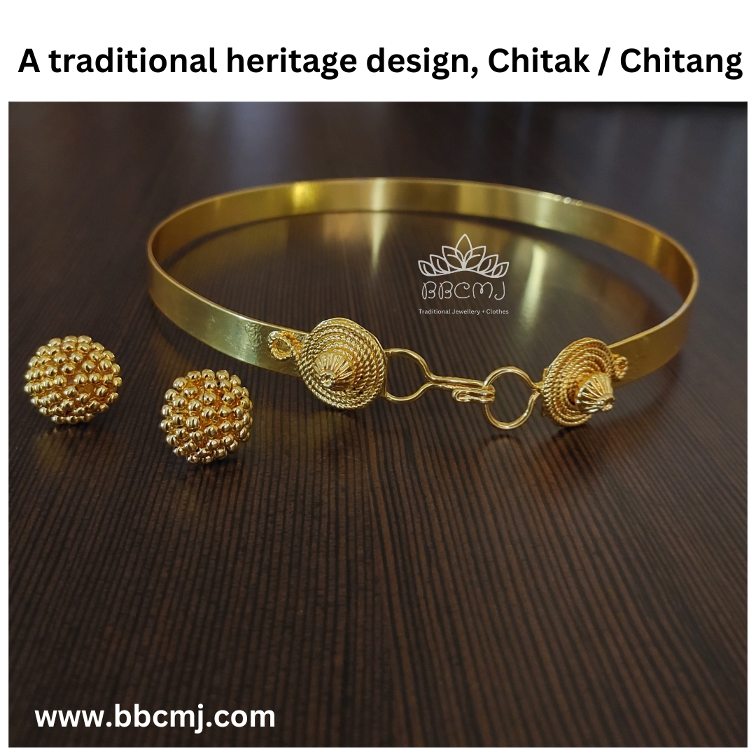 A gold-coated Chitak/Chitang necklace with decorative elements and matching earrings placed on a dark surface.