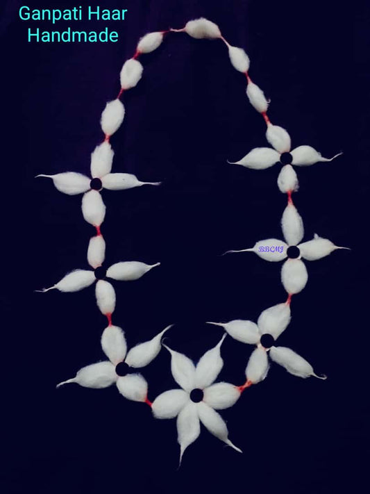 A white cotton vastramala with floral patterns designed for use with Ganpati and Gouri idols.