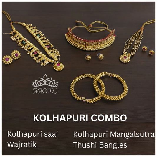 An assortment of traditional Indian gold-coated jewelry including necklaces, earrings, and bangles laid out on a dark surface.