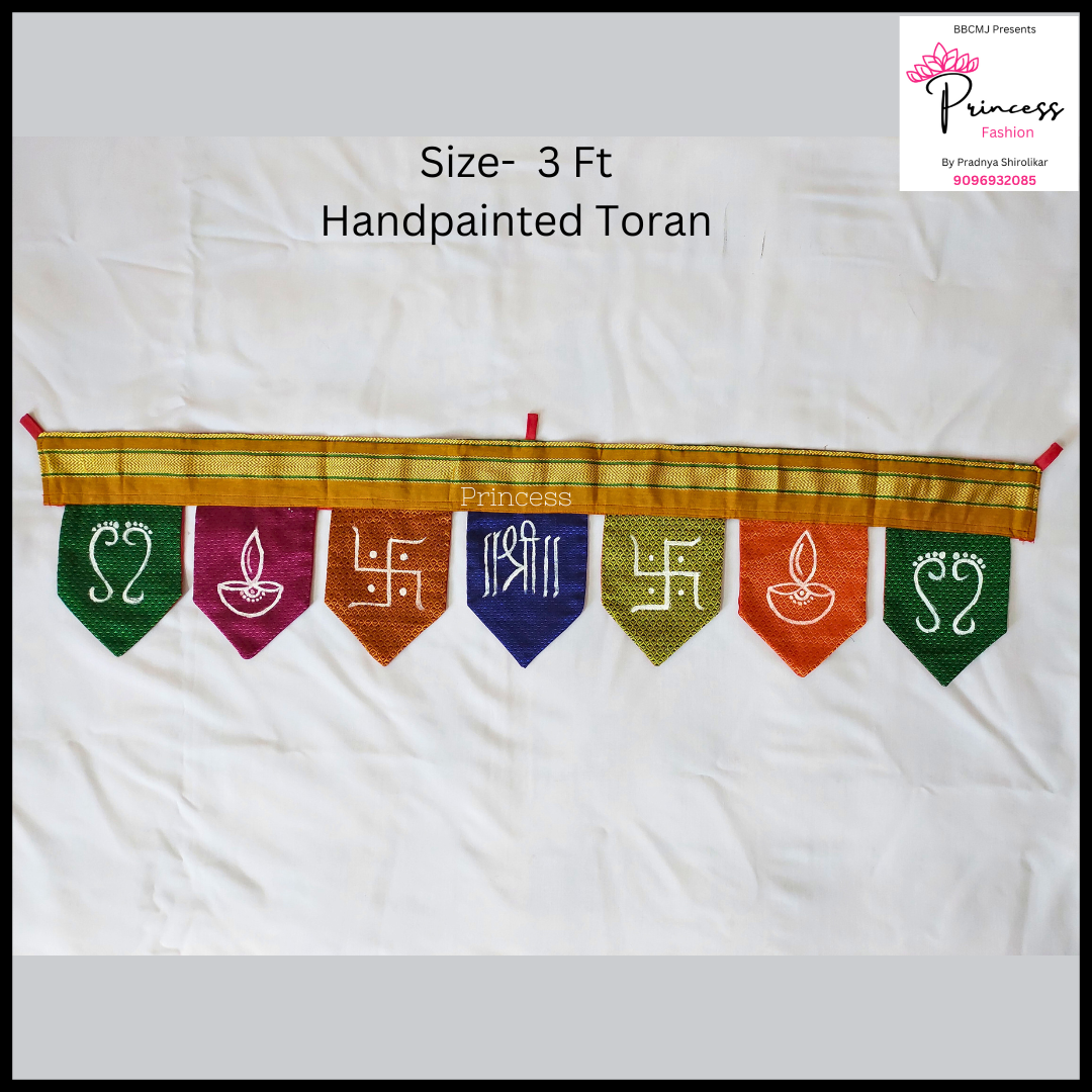 A multicolored handpainted toran with various geometric shapes and symbols, displayed against a white background.